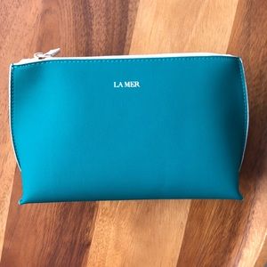 Makeup Bag in Teal by La Mer.